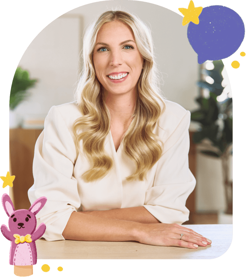 Jess VanderWier seated at a desk and smiling.
