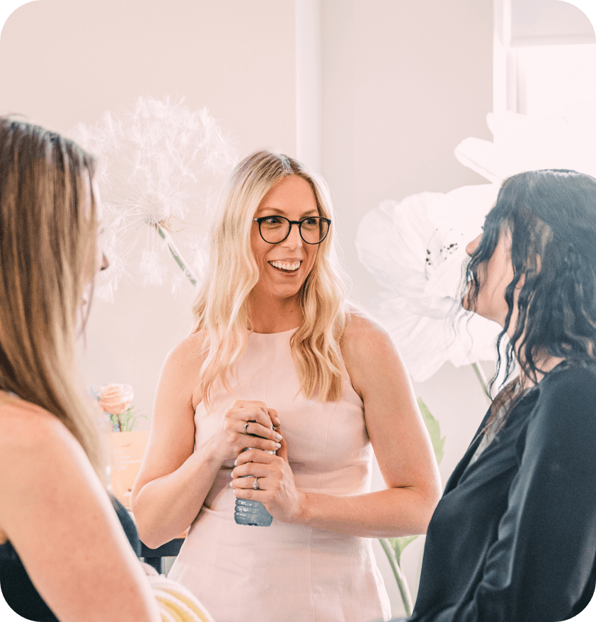 Jess VanderWier talking with two women at an event.