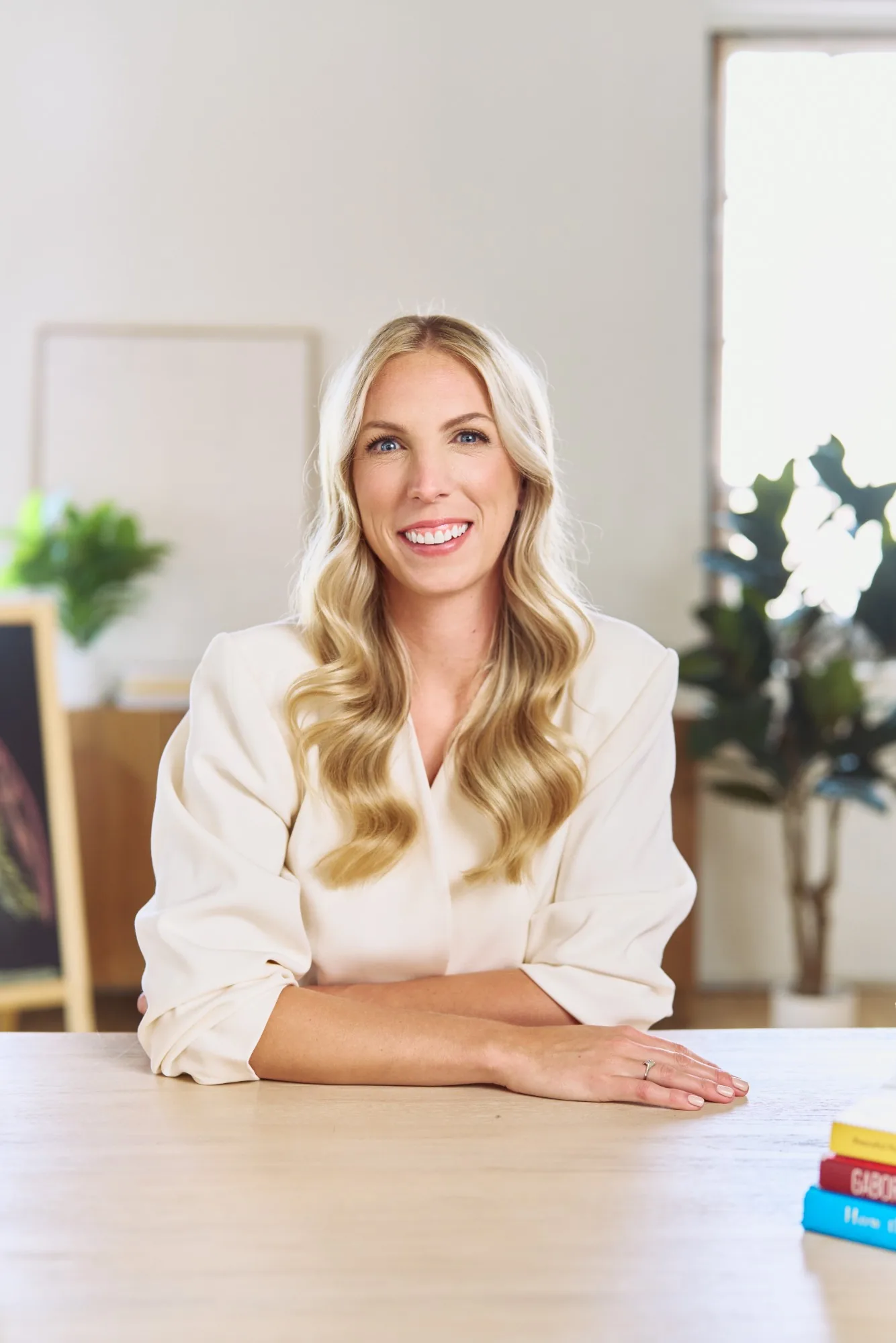 Jess VanderWier seated at a table and smiling